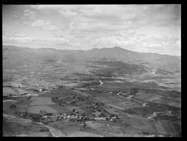 Village and surrounding farmland and river with mountains beyond, Nandi, Fiji