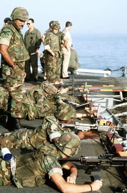 Marines of the 22nd Marine Expeditionary Unit prepare to fire their M-249 squad automatic weapons from the stern of the amphibious assault ship USS SAIPAN (LHA-2) during weapons training held prior Operation Sharp Edge. The SAIPAN is on station off the coast of Liberia