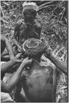 Pig festival, wig ritual: wig frame is fastened to hair