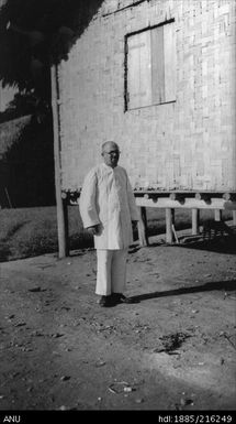 European man standing near a building