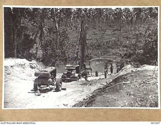 BUMI RIVER, FINSCHHAFEN AREA, NEW GUINEA. 1943-11-24. A PILE BEING HAULED INTO POSITION FOR DRIVING DURING THE CONSTRUCTION OF A BRIDGE ACROSS THE BUMI RIVER BY ENGINEERS OF THE 2/3RD AUSTRALIAN ..