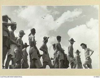 1943-06-09. NEW GUINEA. AN AUSTRALIAN ANTI-AIRCRAFT CREW WATCH A FLIGHT OF THEIR OWN PLANES OVERHEAD