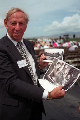 World War II Veteran Dan Wick poses with his treasured photographs of he and his friends taken during the war. He is here for the commemoration of the 50th anniversary of the end of World War II