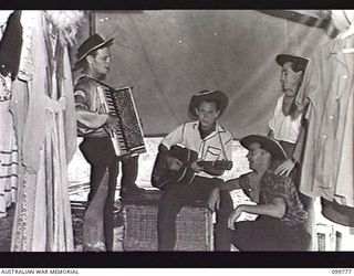 TOROKINA, BOUGAINVILLE, 1945-11-03. LANCE-CORPORAL A. M. RONEY (1), CORPORAL (CPL) J. A. SCOTT (2), CPL T. E. GOWLING (3) AND CRAFTSMAN S. GRAHAM (4) MEMBERS OF THE KOOKAROOS CONCERT PARTY, ..