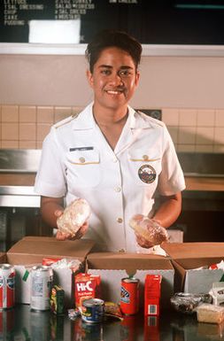 SENIOR AIRMAN Avis Largey of the 15th Services Squadron prepares box lunches at the base's in-flight kitchen