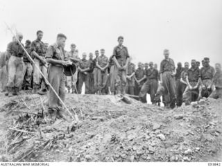 YAMIL AREA, NEW GUINEA, 1945-07-06. CHAPLAIN W.B. HOWDEN, CONDUCTING THE BURIAL SERVICE ON AMUWIMBILL RIDGE, OF A MEMBER OF D COMPANY, 2/5 INFANTRY BATTALION, KILLED DURING THE INITIAL ATTACK ON ..