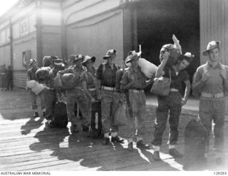 SYDNEY, NSW. 1946-0509. AMF PERSONNEL WAITING TO BOARD THE BUS TO TAKE THEM TO THE LEAVE AND TRANSPORT DEPOT, MARRICKVILLE, AFTER DISEMBARKING FROM THE TROOPSHIP DUNTROON, FROM KURE, MOROTAI AND ..