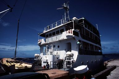 A view of the superstructure of the Micro Pilot, a small ship belonging to the Republic of the Marshall Islands, taken while the ship is moored to a dock