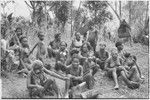 Returned laborers, purification ritual: women and children have gathered to watch