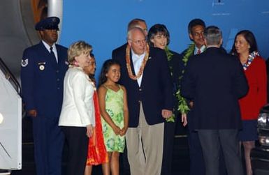 U.S. Vice President Richard B. Cheney and his wife Lynne Ann Cheney pose for a photoraph with Malalapua Pickard (green dress), 8, and Puaena Pickard (red dress), 10, who greeted the vice president and his wife with traditional Hawaiian leis at Hickam Air Force Base, Hawaii, on Oct. 31, 2004.(PHOTO by Michael Dey, CIV) (Released)