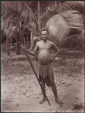 Man holding a fighting club, Torres Islands, 1906 / J.W. Beattie