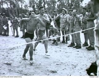 THE SOLOMON ISLANDS, 1945-01-12. CLOSE FINISH TO A WALKING EVENT AT A COMBINED ANZAC SPORTS MEETING AT BOUGAINVILLE ISLAND. (RNZAF OFFICIAL PHOTOGRAPH.)