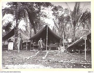SWAN BEACH, JACQUINOT BAY. NEW BRITAIN. 1944-12-10. BATTALION HEADQUARTERS, 11 INFANTRY BATTALION, 13 INFANTRY BRIGADE, 5 DIVISION AT THE UNIT CAMP AREA NEAR THE WUNUNG RIVER