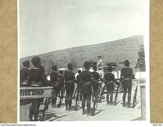 KILA, NEW GUINEA, 1943-10-24. REAR VIEW OF MAJOR-GENERAL B.M. MORRIS, DSO., GENERAL OFFICER COMMANDING, AUSTRALIAN AND NEW GUINEA ADMINISTRATIVE UNIT ADDRESSING NATIVES AT THE NATIVE LABOUR CAMP. ..