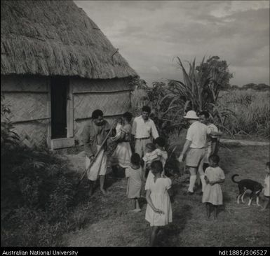 Field Officer with farmer and his family