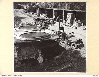 MAKOW, NEW GUINEA. 1945-08-06. ENGINEERS OF HEADQUARTERS COMMAND, AUSTRALIAN ARMY SERVICE CORPS, 6 DIVISION, PUMPING WATER UP A 300 FOOT GRADE TO CANVAS STORAGE TANKS NEAR THE SUMMIT OF THE BIG ..