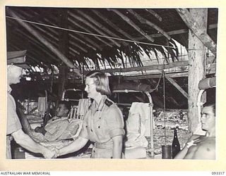 LAE AREA, NEW GUINEA, 1945-06-28. HIS ROYAL HIGHNESS, THE DUKE OF GLOUCESTER, GOVERNOR-GENERAL OF AUSTRALIA (1) VISITING ONE OF THE WARDS AT 2/7 GENERAL HOSPITAL, DURING HIS TOUR OF INSPECTION OF ..