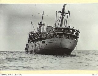OFF PORT MORESBY, PAPUA. 1942-08-30. THE M.V. MALAITA WITH HER STERN WELL CLEAR. SHE WAS TORPEDOED BY AN ENEMY SUBMARINE OFF PORT MORESBY AND LATER TOWED IN TO THE HARBOUR. ALL THE CREW WERE SAVED, ..