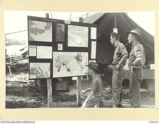 MILILAT, NEW GUINEA. 1944-06-19. NX120889 CORPORAL D.P. YOUNG, AUSTRALIAN ARMY EDUCATION SERVICE (1), N268207 PRIVATE L.H. BODYCOTE, HEADQUARTERS CENTRE 5TH DIVISION, (2), AND TX2695 WARRANT ..