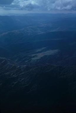 [Aerial view of forest covered mountains in Fiji]