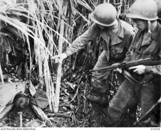 1943-01-27. PAPUA. SANANANDA AREA. A JAPANESE WAS SEEN BY A NATIVE BOY TO RUN INTO A DUGOUT FROM WHERE HE IMMEDIATELY OPENED FIRE AT AUSTRALIANS CARRYING AMMUNITION TOWARDS THE FRONT LINE AT BUNA. ..