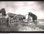 NAURU ISLAND. 1945-09-16. A MEMBER OF THE 31/51ST INFANTRY BATTALION INSPECTING THE STEEL CANTILEVER PHOSPHATE LOADING WHARF OF THE BRITISH PHOSPHATE COMMISSION WHICH WAS WRECKED BY A GERMAN RAIDER ..
