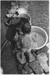 Felicia Keesing and Kwaio boy play with tub of water