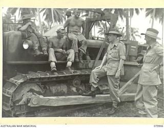 AITAPE, NEW GUINEA. 1945-03-23. LORD WAKEHURST, KCMG, GOVERNOR OF NEW SOUTH WALES (4) SPEAKING WITH MEMBERS OF THE 2/1ST RAILWAY CONSTRUCTION PLATOON MANNING A CATERPILLAR TRACTOR AT THE BEACHHEAD ..