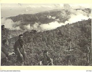 WAREO, PAPUA, NEW GUINEA, 1944-03-29. THE VIEW FROM B COMPANY, 4TH FIELD AMBULANCE REST CAMP WITH FINSCHHAFEN IN THE DISTANCE. THIS VIEW IS TAKEN FROM A LOOKOUT POINT OVERLOOKING A RECENT BATTLE ..