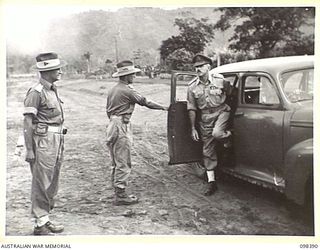 RABAUL, NEW BRITAIN. 1945-10-28. MAJOR GENERAL K.W. EATHER, GENERAL OFFICER COMMANDING 11 DIVISION, ARRIVING AT THE PARADE GROUND TO ATTEND A CEREMONIAL PARADE AND MARCH PAST BY TROOPS OF 11 ..