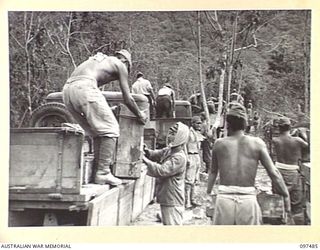 BLANCHE BAY, RABAUL, NEW BRITAIN. 1945-10-03. JAPANESE TROOPS LOADING CASES OF GRENADES ONTO TRUCKS. THEY WILL BE TRANSPORTED TO A BARGE POINT FOR DUMPING AT SEA UNDER 28 INFANTRY BATTALION ..