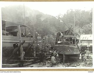 KWIARA, CHINA STRAITS, 1943-07-06. THE AM-48 (ARMY) AND THE 016-2 (RAAF) ON THE SLIPS OF THE 1ST AUSTRALIAN WATER TRANSPORT GROUP MAINTENANCE BASE UNDERGOING REPAIRS AND MAINTENANCE