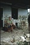 Father Laughman in a chair in front of his house