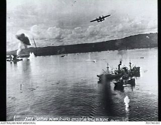 Wewak, NG. 1943-09-02. Aerial photograph of an attack by two Mitchell B25 bomber aircraft of No. 405 Squadron, No. 38 Bomber Group, US Army Air Force, on Japanese shipping in the harbour