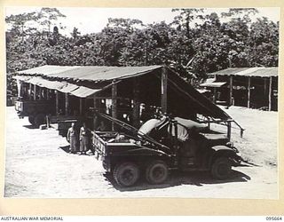 BOUGAINVILLE. 1945-08-30. THE TYPE OF BUILDING CONSTRUCTED FROM LOCAL TIMBER ERECTED AT 113 BRIGADE WORKSHOP CORPS OF AUSTRALIAN ELECTRICAL AND MECHANICAL ENGINEERS, TO HOUSE WORKSHOPS. BREAKDOWN ..