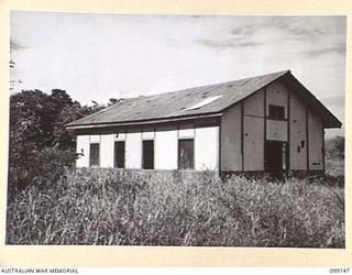 LAE, NEW GUINEA. 1945-11-26. A NATIVE SCHOOL FORMERLY OPERATED BY THE LUTHERAN MISSION SOCIETY. IT WAS USED BY THE JAPANESE AS PART OF THEIR HOSPITAL. AFTER THE RECAPTURE OF LAE IT WAS USED BY THE ..