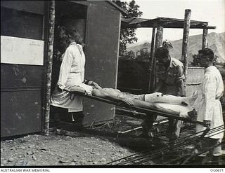 NADZAB, NEW GUINEA. C. 1944-02. AT NO. 24 MEDICAL CLEARING STATION RAAF LEADING AIRCRAFTMAN (LAC) J. C. KAVANAGH, HURLSTONE PARK, NSW, WHO WAS ACCIDENTALLY WOUNDED IN THE LEG BY MACHINE GUN, IS ..