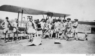 Bomana, Laloki River Area, Port Moresby, New Guinea. 1943-05. Informal group portrait at Berry airstrip of ground crew of No. 33 Squadron RAAF in front of a Tiger Moth aircraft under maintenance. ..