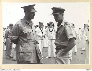 AT SEA OFF RABAUL, NEW BRITAIN. 1945-09-06. COLONEL R.W. SAVIGE, CHIEF STAFF OFFICER AND WING COMMANDER MATHISON ON BOARD THE AIRCRAFT CARRIER HMS GLORY, WAITING FOR THE ARRIVAL OF GENERAL H. ..