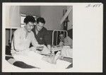 Pfc. Kiyashi Yonemori at the Moore General Hospital, Swannanoa, North Carolina, reads a letter from home. With the 100th Battalion