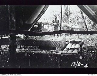 SEPIK RIVER AREA, NEW GUINEA. 1943-08-13. INTERIOR VIEW OF THE TENT DINING ROOM AND WIRELESS STATION (ATR4) OF `LOCUST' PARTY, M SPECIAL UNIT, SERVICES RECONNAISSANCE DEPARTMENT, ALLIED ..