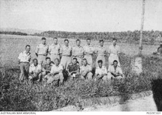 Madang, New Guinea, 1945-07. Outdoors group portrait of the Operations and Intelligence officers of all three services serving at Headquarters, RAAF Northern Command (NORCOM). Left to right, back ..