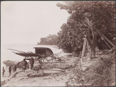 Men and children standing next to a canoe on a beach at Nukapu, Reef Islands, 1906 / J.W. Beattie