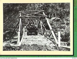 DUMPU AREA, NEW GUINEA. 1944-04-18. MEMBERS OF THE 15TH FIELD COMPANY, ROYAL AUSTRALIAN ENGINEERS IN A JEEP CROSSING THE 60 FOOT SPAN OF A TRUSSED BRIDGE ACROSS THE FARIA RIVER