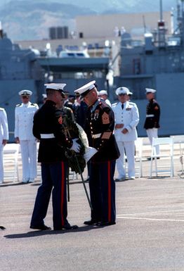 Marine Sergeant Major Allan J. Kellogg, right, Medal of Honor recipient for duty in Vietnam, presents a wreath and Purple Heart to honor the Unknown Serviceman of the Vietnam Era. The serviceman's casket will be transported California aboard the frigate USS BREWTON (FF 1086) and then transferred to Arlington National Cemetery for interment at the Tomb of the Unknowns