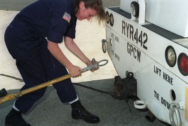 AIRMAN (AN) Diana Pitstick is unhooking a Mark 7 weapons cart from an auxiliary power unit/tow tractor on the Patrol Squadron Forty-Seven (VP-47) tarmac