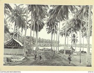 MILILAT, NEW GUINEA. 1944-08-07. LOOKING DOWN THE ROAD FROM THE CAMP OFFICE TOWARDS THE LANDING POINT AT HEADQUARTERS, 5TH DIVISION