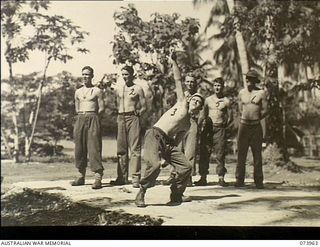 MADANG, NEW GUINEA. 1944-06-17. TROOPS PARTICIPATING IN THE HAND GRENADE THROWING EVENT DURING THE TABLOID SPORTS MEETING CONDUCTED BY HEADQUARTERS 15TH INFANTRY BRIGADE WITHIN THE SIAR PLANTATION. ..