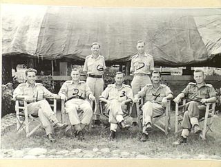 Outdoor group portrait of officers of the 18th Field Ambulance outside their mess. Identified standing in the back row from left to right: NX102477 Lieutenant (Lt) John Cyril Selwood and NX113198 ..