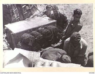 BOUGAINVILLE. 1945-05-21. TROOPS OF 24 INFANTRY BATTALION USING ALL AVAILABLE SPACE ON MATILDA TANKS TO TRANSPORT GEAR TO C COMPANY POSITION ON EGAN'S RIDGE. THEY ARE HOOKING UP AN AMMUNITION ..